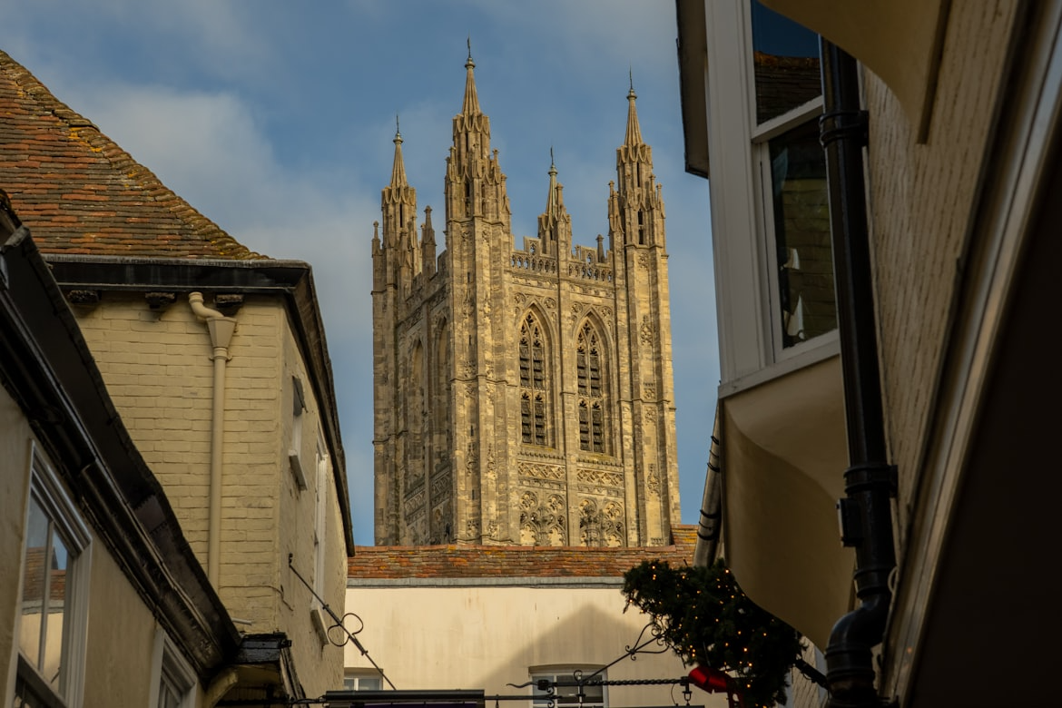 Tower of Canterbury Cathedral rises above narrow city streets